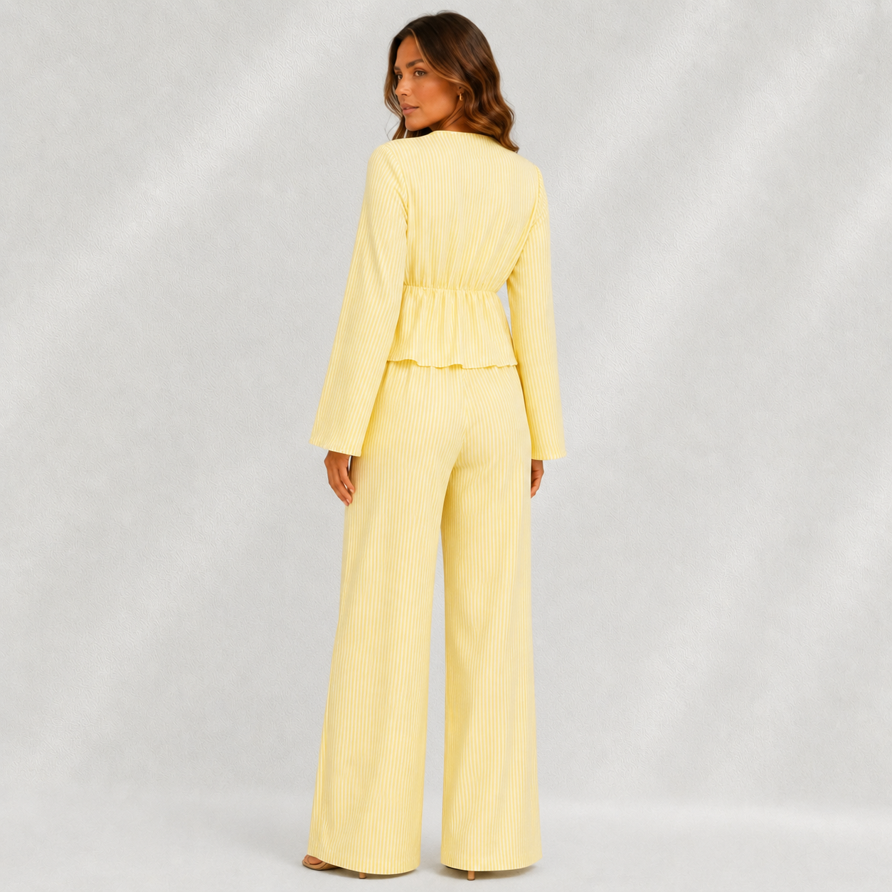 Vue de dos d’un ensemble femme jaune rayé avec haut fluide et pantalon large