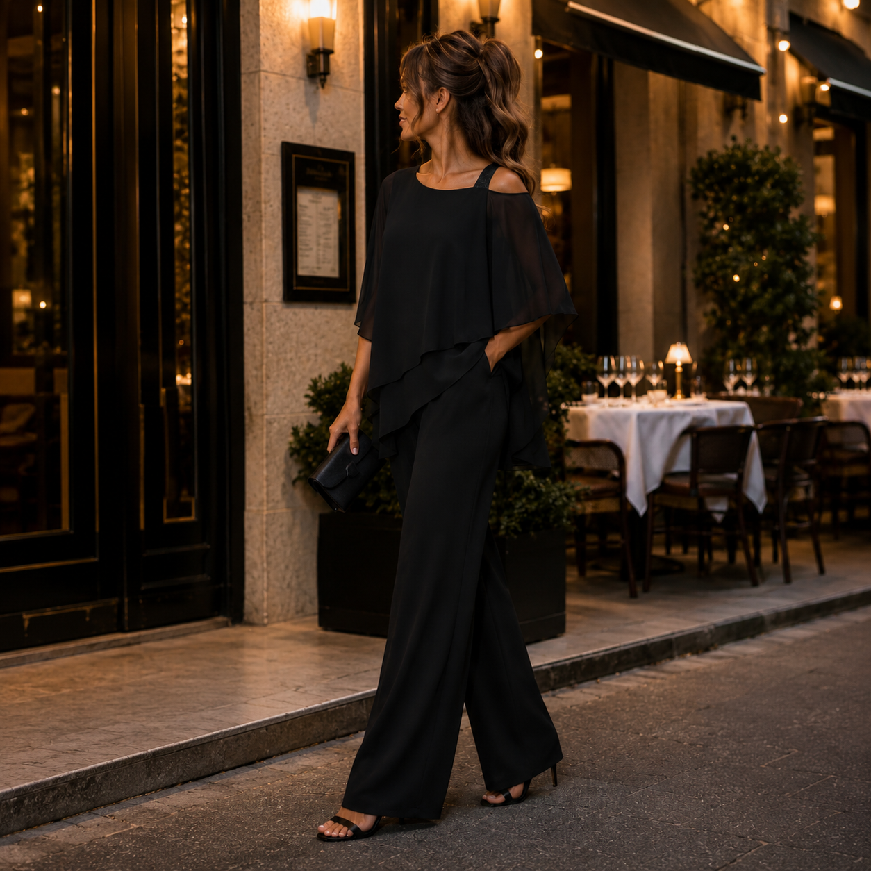 Robe pantalon de soirée femme noire devant restaurant chic