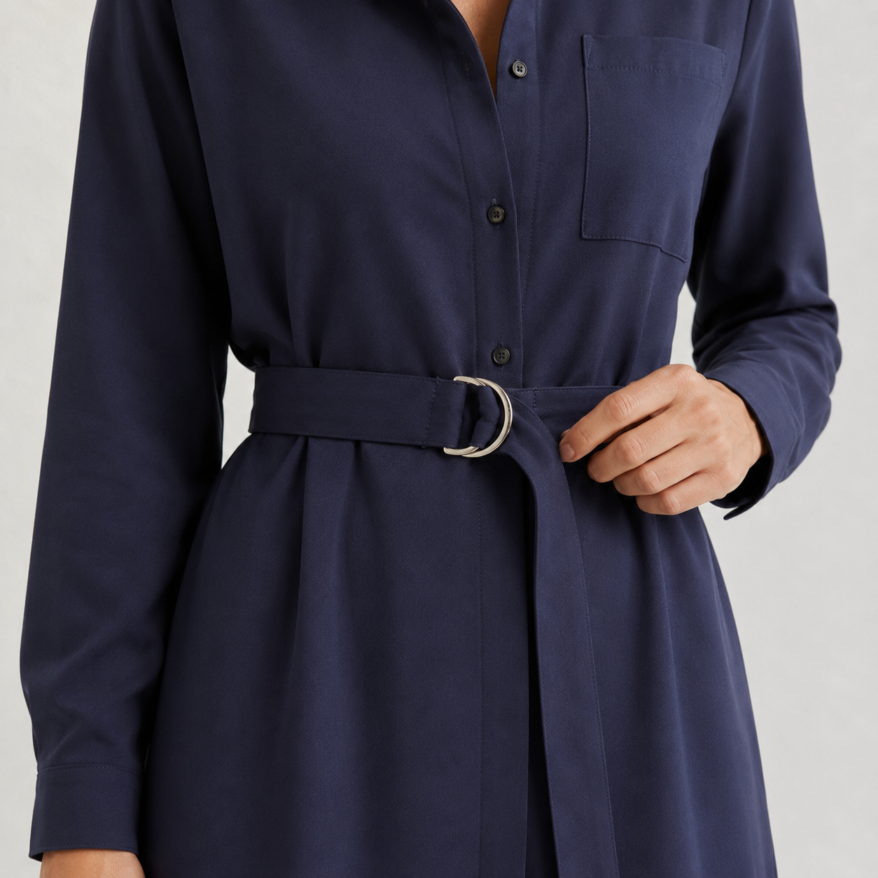 Gros plan sur la ceinture à boucle métallique de la robe chemise femme bleu marine